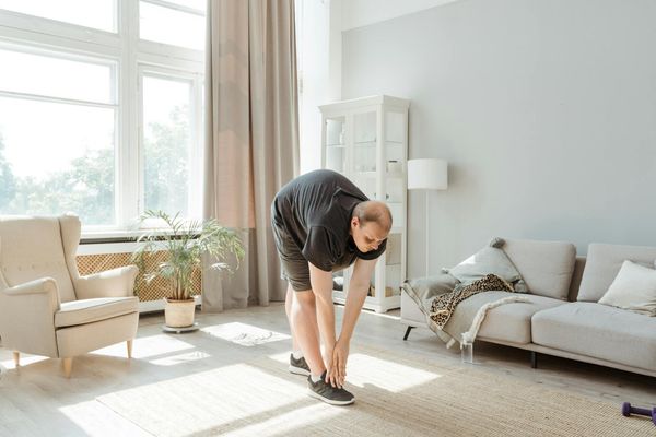 Person doing relaxing exercises in a bright modern room.